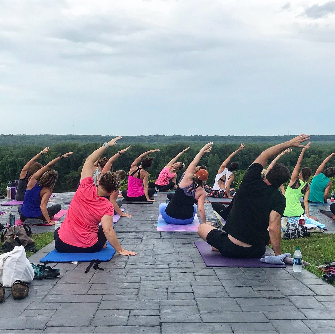 Katie leading an outdoor group yoga class at an overlook